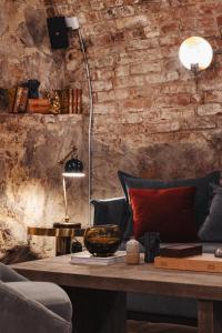 a room with a table with a couch and a lamp at Hotel Frantz, WorldHotels Crafted in Stockholm