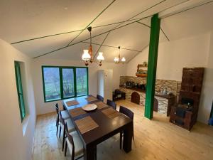a dining room with a table and chairs at Casa Verde in Băile Olăneşti +17 photos