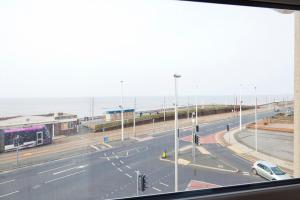 a view from a window of a street with a car at Queens Mansions: Empress Suite in Blackpool
