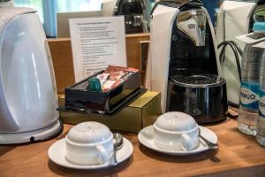 a counter with two cups and a blender and a tea set at Bagan Thiripyitsaya Sanctuary Resort in Bagan