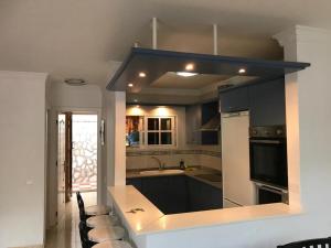 a kitchen with a sink and a stove top oven at Bungalow Isla Margarita in Puerto Rico de Gran Canaria