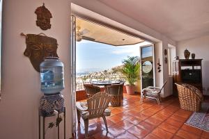 a living room with a view of a table and chairs at Casa Isabel a Boutique Hilltop Inn in Puerto Vallarta