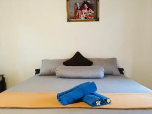 a bed with two blue pillows on top of it at Ampik Batur in Kintamani