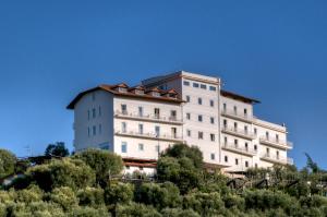a large white building on top of a hill at Grand Hotel Aminta in Sorrento
