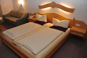 a hotel room with two beds and two nightstands at Hotel Gruberhof Innsbruck-Igls- bed & breakfast in Innsbruck