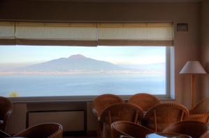 a room with a window with a view of a mountain at Grand Hotel Aminta in Sorrento