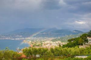 a rainbow over a city with a town and a lake at Grand Hotel Aminta in Sorrento