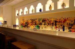 a bar with a lot of bottles on the wall at Grand Hotel Aminta in Sorrento