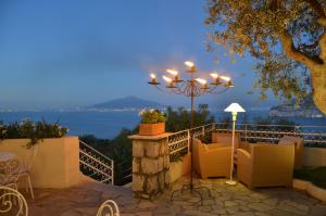 a patio with a view of the ocean at night at Grand Hotel Aminta in Sorrento