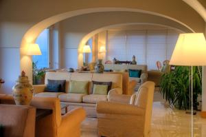 a living room with couches and chairs in a room at Grand Hotel Aminta in Sorrento