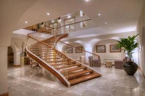 a wooden spiral staircase in a living room at Grand Hotel Aminta in Sorrento