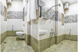 y baño con aseo, lavabo y ducha. en FabExpress Santhi Inn, Promenade Beach en Pondicherry