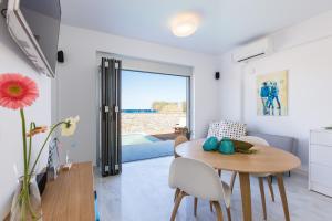 a kitchen and dining room with a table and chairs at Thalasses in Adelianos Kampos