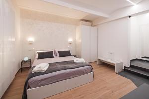 a bedroom with a large bed and a staircase at B&BO la Frasca in Bologna
