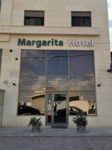 a margarita hotel with a reflection in the windows at Margarita Hotel in Amman