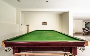 a pool table in the middle of a room at Changkat Duta Luxury Villa (Event Space) in Kuala Lumpur