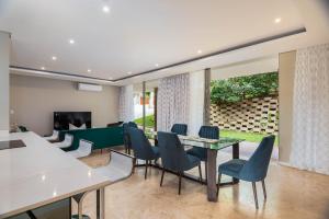 a dining room with a pool table and chairs at Zimbali Coastal Resort - ZKY1 - 3 Bedroom Apartment in Ballito