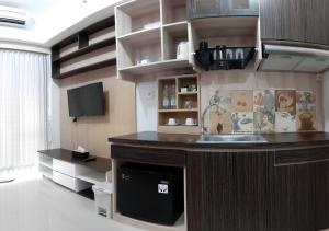 a kitchen with a counter and a sink in a room at Apartemen Taman Melati Sinduadi 61 in Yogyakarta