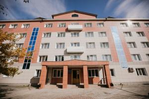 a large white building with blue windows at Hotel Iren in Kungur