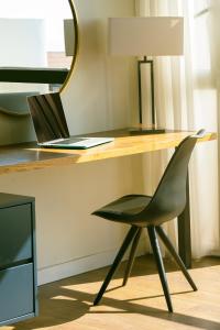 a desk with a laptop computer sitting on top of it at Marine Heights Suites in Herzliya