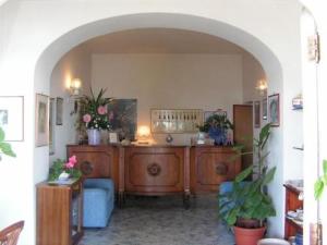a living room filled with furniture and plants at Open Gate in Praiano