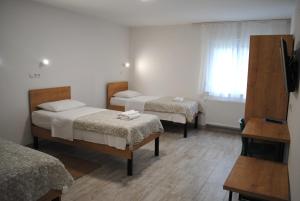 a hotel room with two beds and a window at Hotel Fala in Zagreb