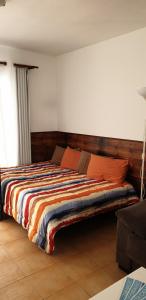a bedroom with a large bed with a wooden headboard at VV Apart 10A in Caleta De Fuste +12 photos