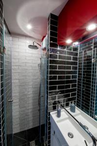 a bathroom with a sink and a glass shower at Central studio in Ioannina in Ioannina