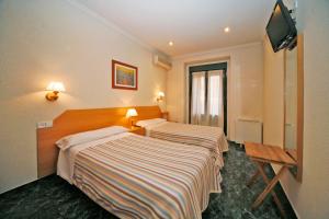 Postel nebo postele na pokoji v ubytování Hostal Prim