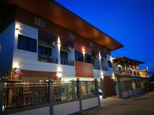 a building with a fence in front of it at ช้างเผือกเกสต์เฮ้าส์ Changphueak Guesthouse in Nan