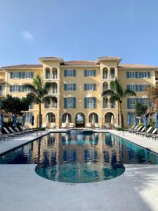 a large building with a large swimming pool in front of it at Villa Renaissance in Grace Bay