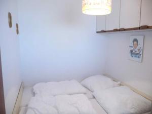a small room with two white pillows on a bed at STHS79125-FeWo-Oostseebreker in Staberdorf