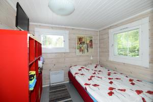 a bedroom with a bed with flowers on it at Pikku Torppa Cottage in Kotka