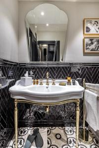 a bathroom with a sink and a mirror at Palazzo Bianca Cappello Residenza d'Epoca in Florence
