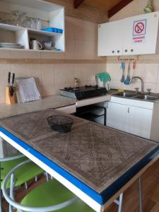 a kitchen with a sink and a counter top at Las 3 Golondrinas in El Quisco