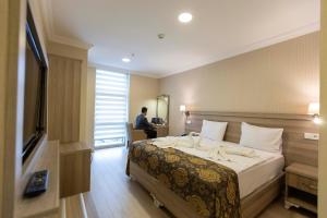 Ένα ή περισσότερα κρεβάτια σε δωμάτιο στο World Point Hotel Besyol