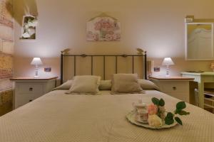 Postel nebo postele na pokoji v ubytování B&B Le Oasi