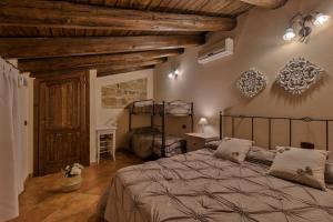 a bedroom with a large bed and a wooden ceiling at B&B Le Oasi in Terrasini