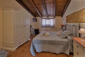 Postel nebo postele na pokoji v ubytování B&B Le Oasi