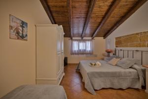 Postel nebo postele na pokoji v ubytování B&B Le Oasi