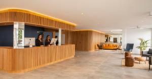 a lobby with two people standing at a counter at Oasis Lanz Beach Mate in Costa Teguise