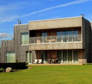 a large building with a lawn in front of it at Kaluri Residence in Kuressaare