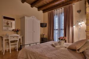 Postel nebo postele na pokoji v ubytování B&B Le Oasi