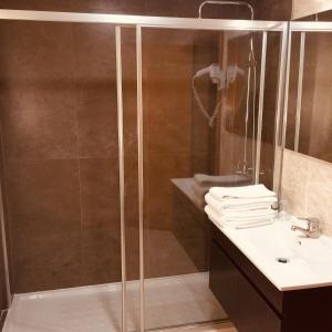 a bathroom with a shower and a sink at Hotel Europa in Vila Pouca de Aguiar