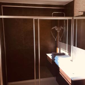a bathroom with a glass shower with a sink at Hotel Europa in Vila Pouca de Aguiar +21 photos