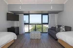 a living room with two beds and a couch at Sky Blue Guest House in Kenton on Sea