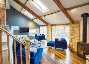 a living room with blue furniture and a fireplace at Host & Stay - The Old Pottery in Pickering