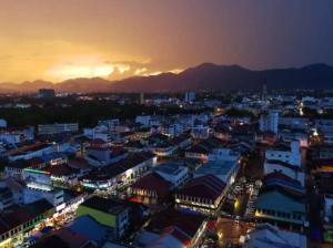 a view of a city at night with the sunset at The Octagon Ipoh - Home Stay in Ipoh