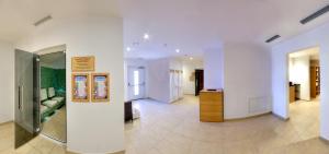 a living room with white walls and a hallway at Hotel Rezia in La Villa