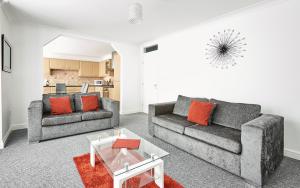 a living room with two couches and a table at Fabrik Apartments - Harrowside by Blackpool Service Apartements in Blackpool
